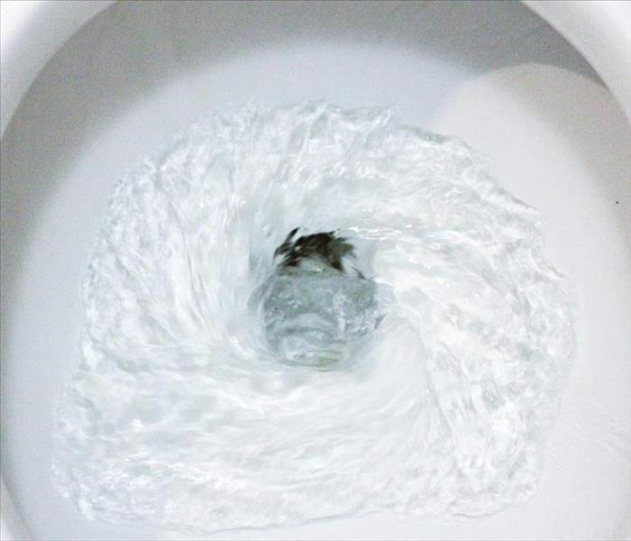 Water in toilet bowl flushing