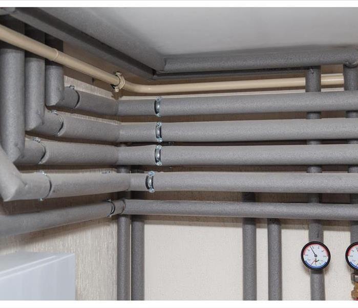 The pipelines in the insulation and pressure gauges flow and return pipes in the boiler room of a private house household
